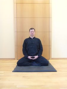 Meditierdender Mann auf dem Boden